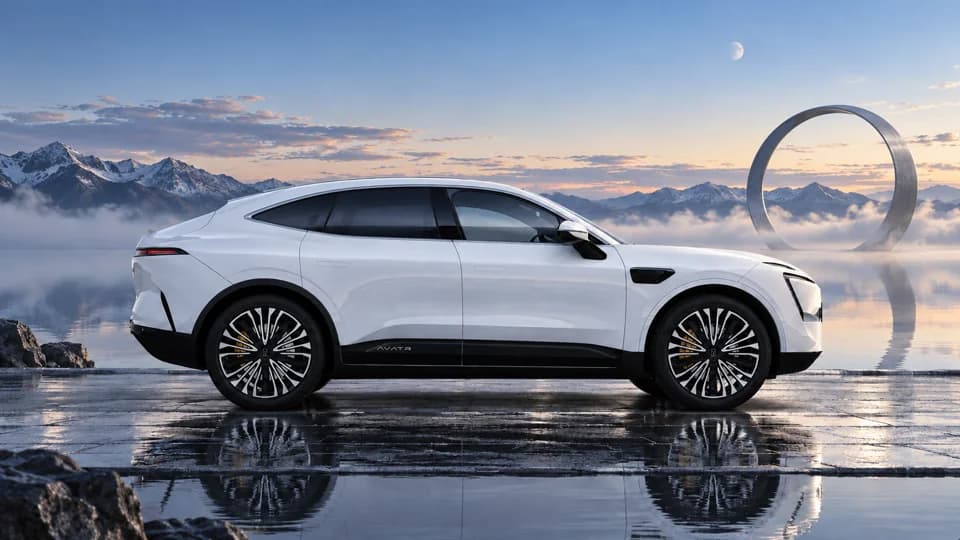 White AVATR 11 in a reflective mountain landscape