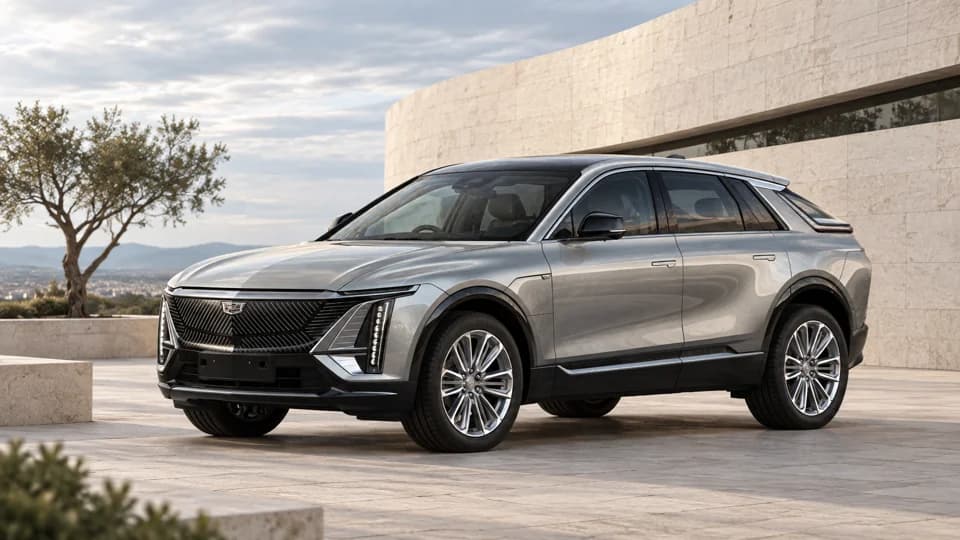 Silver Cadillac beside contemporary stone architecture